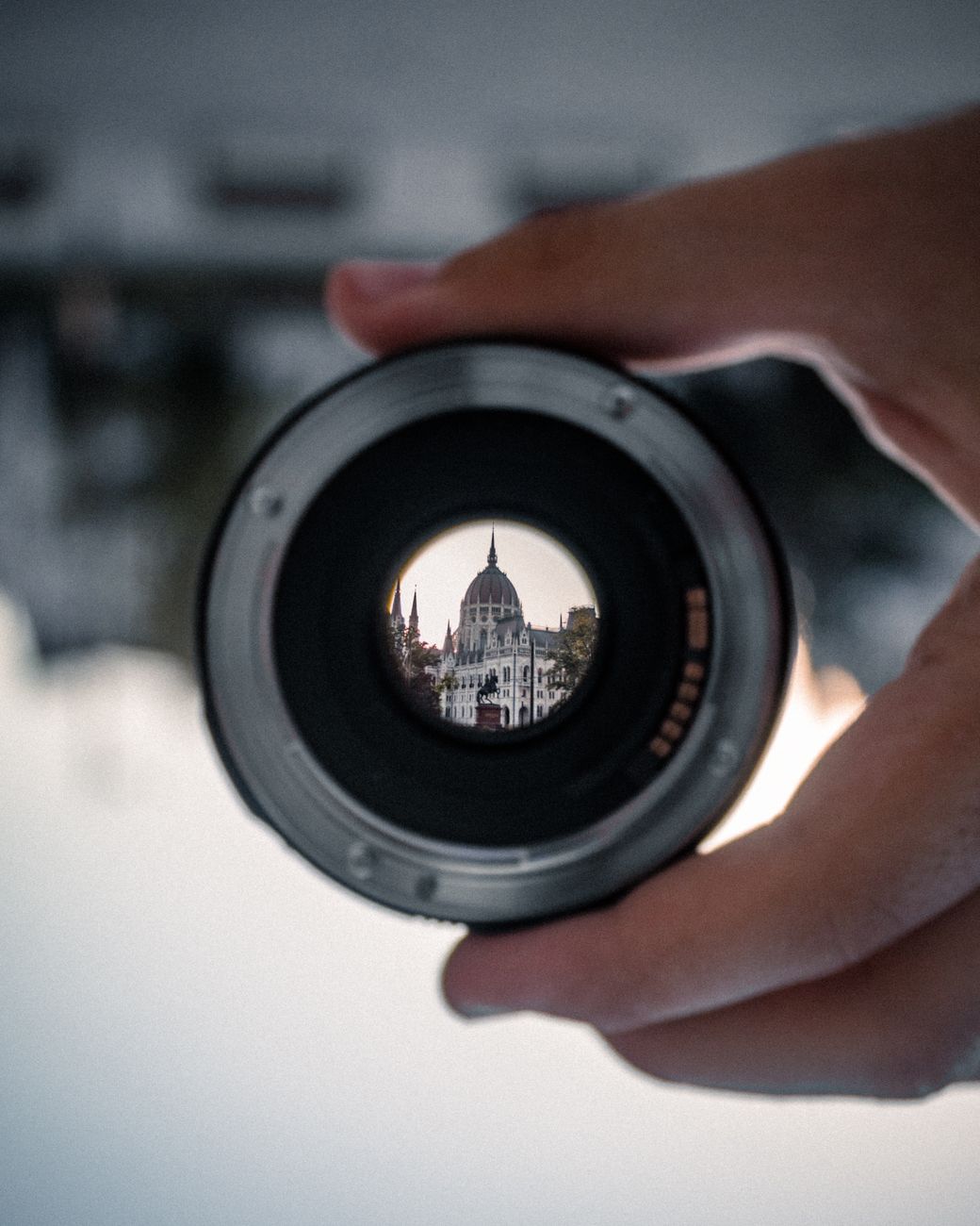 person holding black camera lens